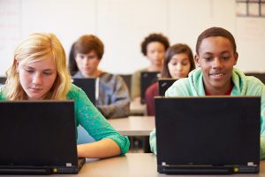students in class on laptops